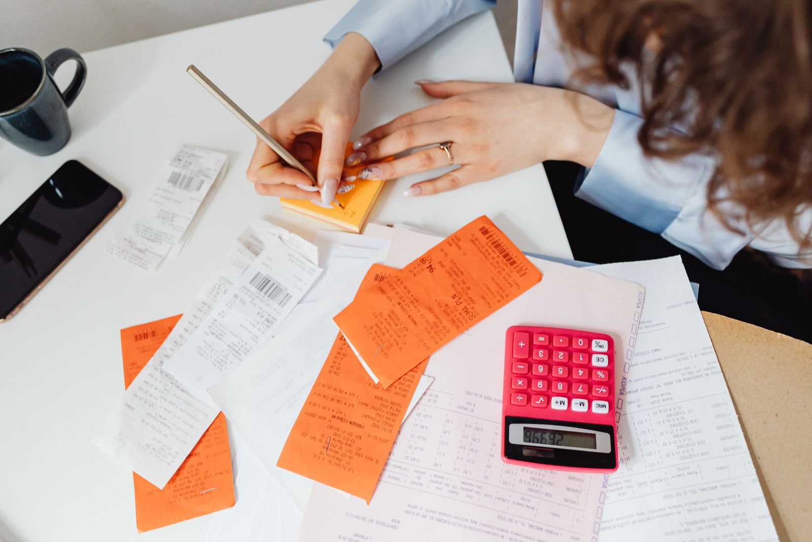 Receipts, sticky notes and a calculator on a desk